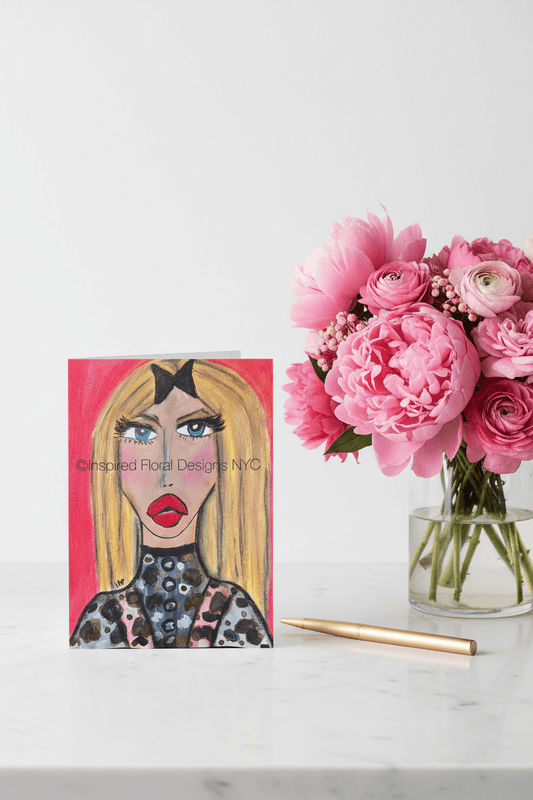 stylized face by inspired floral designs nyc greeting card with pink peonies in a vase on a marble table with gold pen