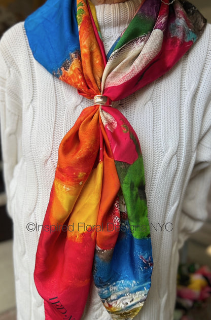 Colorful scarf tied around a person's neck with a blurred background inspired floral designs nyc copyright fragmented blossoms