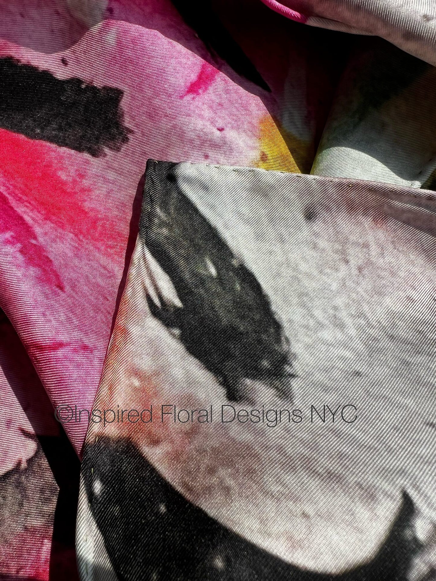 Close-up of fabric with floral design and 'Inspired Floral Designs NYC' branding peace scarf  copyright