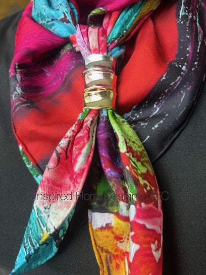 Colorful abstract scarf petals in the wild by inspired floral designs nyc with a decorative knot rings on a black background copyright