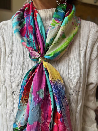 Colorful floral abstract scarf with floral design worn by a person in a white sweater titled petals unleashed by inspired floral designs nyc copyright