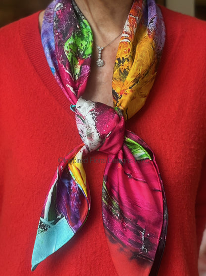Colorful floral abstract scarf titled petals in the wild the edit floral art in silk on a red sweater by inspired floral designs nyc copyright