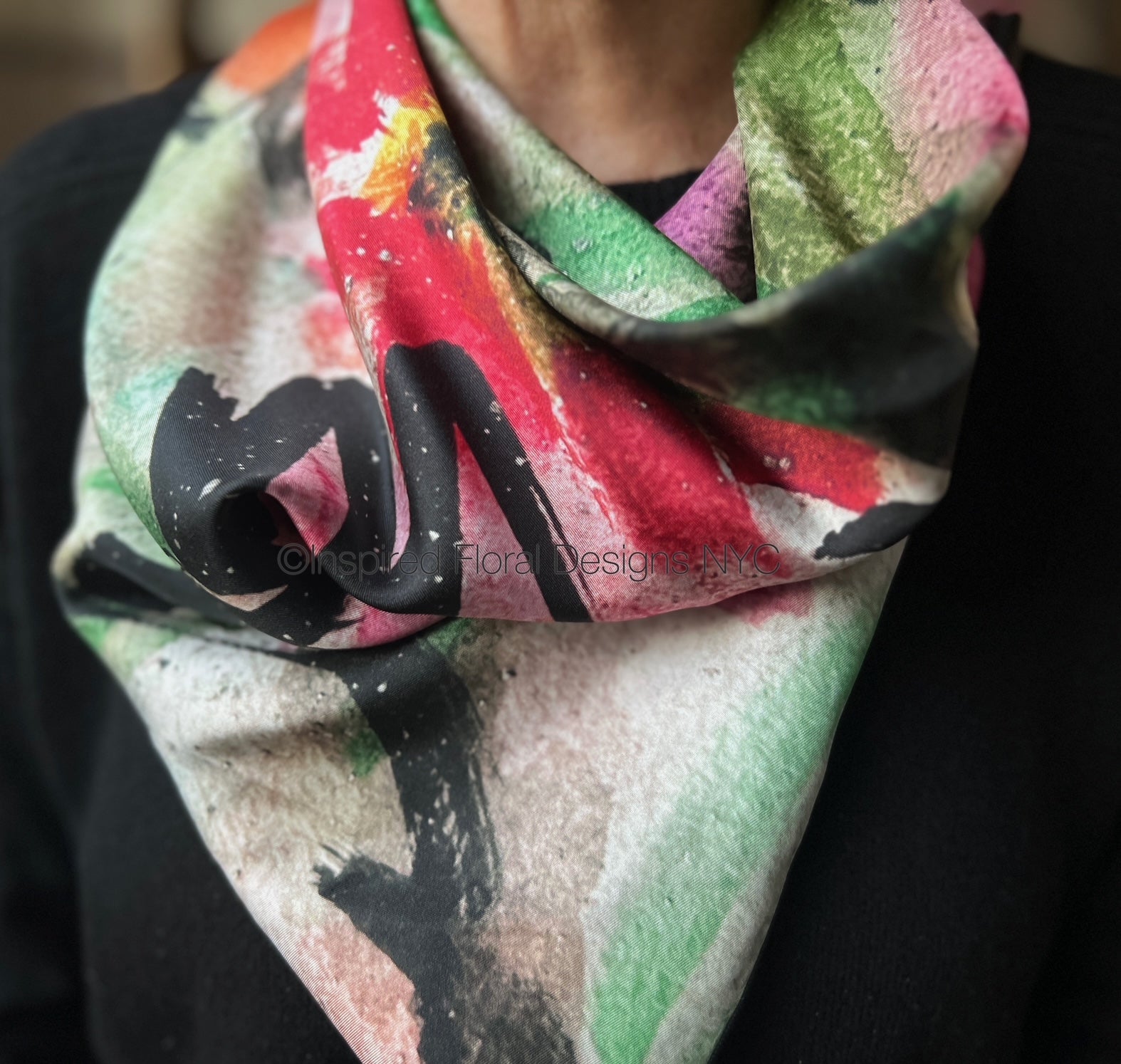 Colorful floral scarf with abstract design worn by a person for inspired floral designs nyc copyright peace scarf the edit floral art in silk