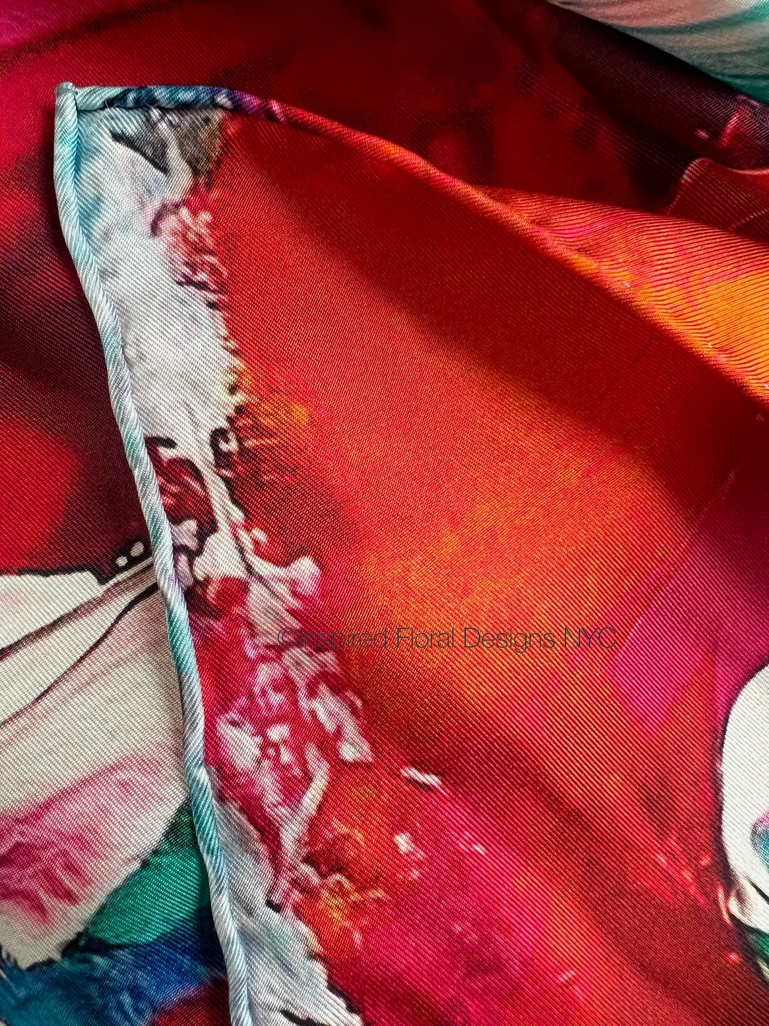 Close-up of a colorful fabric with intricate patterns on a red background inspired floral designs nyc copyright the edit floral art in silk