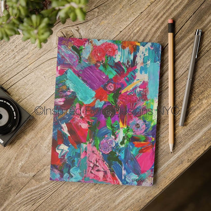 Colorful abstract notebook on a wooden surface with a pen and pencil by inspired floral designs nyc