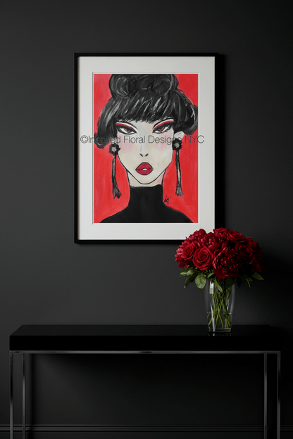 Framed artwork of a stylized face with red background on a black wall above a black console table with a vase of red roses by Inspired Floral Designs NYC LLC Copyright