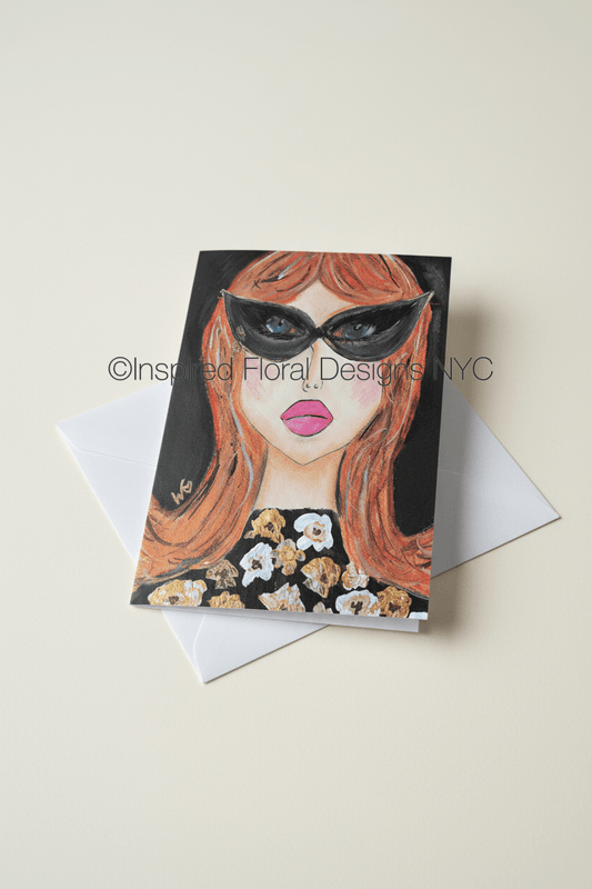 A square greeting card by Whitney at Inspired Floral Designs NYC LLC featuring a stylized illustration of a woman with orange hair, black sunglasses, and pink lips, shown with a white envelope on a light beige background. A watermark reading 'Inspired Floral Designs NYC' is visible across the center. Copyright