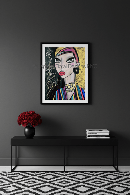 Framed artwork of a stylized woman's face on a dark wall with a black console table and decorative items by whitney inspired floral designs nyc llc copyright