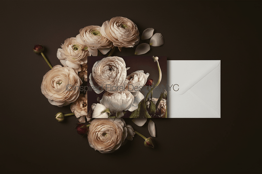 Floral arrangement with a card and envelope on a dark background by inspired floral designs nyc llc copyright