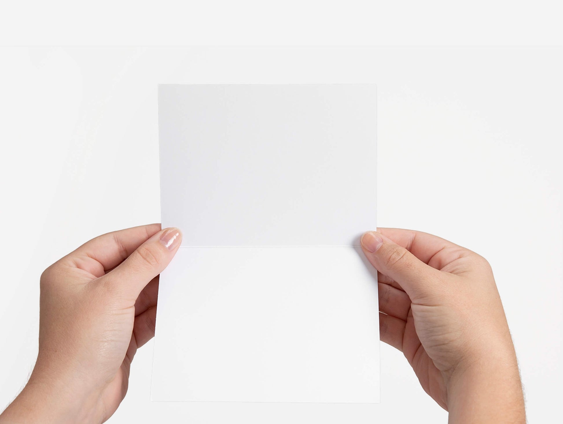 hand holding greeting card that is blank inside
