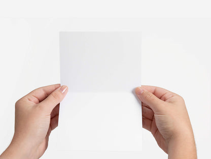 hand holding greeting card that is blank inside