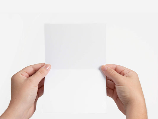 hand holding greeting card that is blank inside