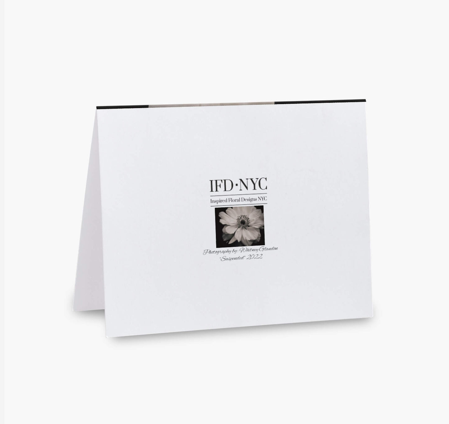 back of greeting card with black and white flower suspended