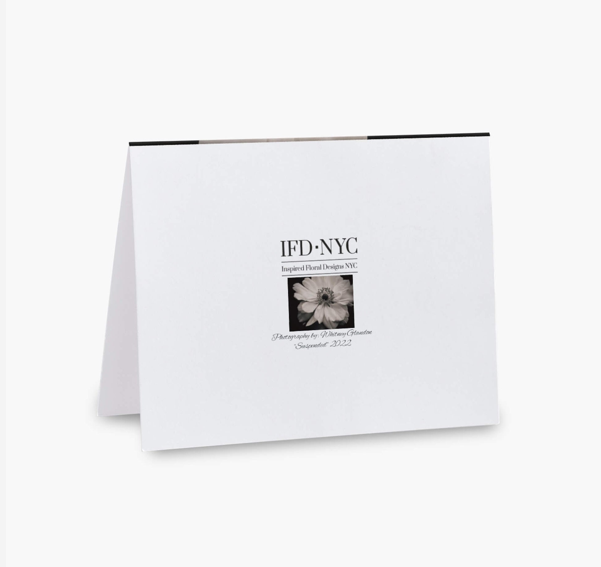 back of greeting card with black and white flower suspended