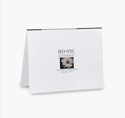 back of greeting card with black and white flower suspended