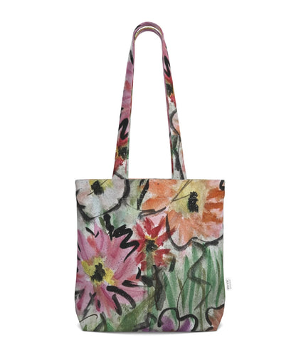 A canvas tote bag with a colorful floral watercolor print by Barbara at Inspired Floral Designs NYC and matching shoulder straps, shown against a plain white background.