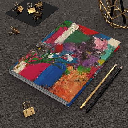 Colorful notebook with artistic design painting titled fragmented blossoms at inspired floral designs nyc on a dark surface with office supplies.