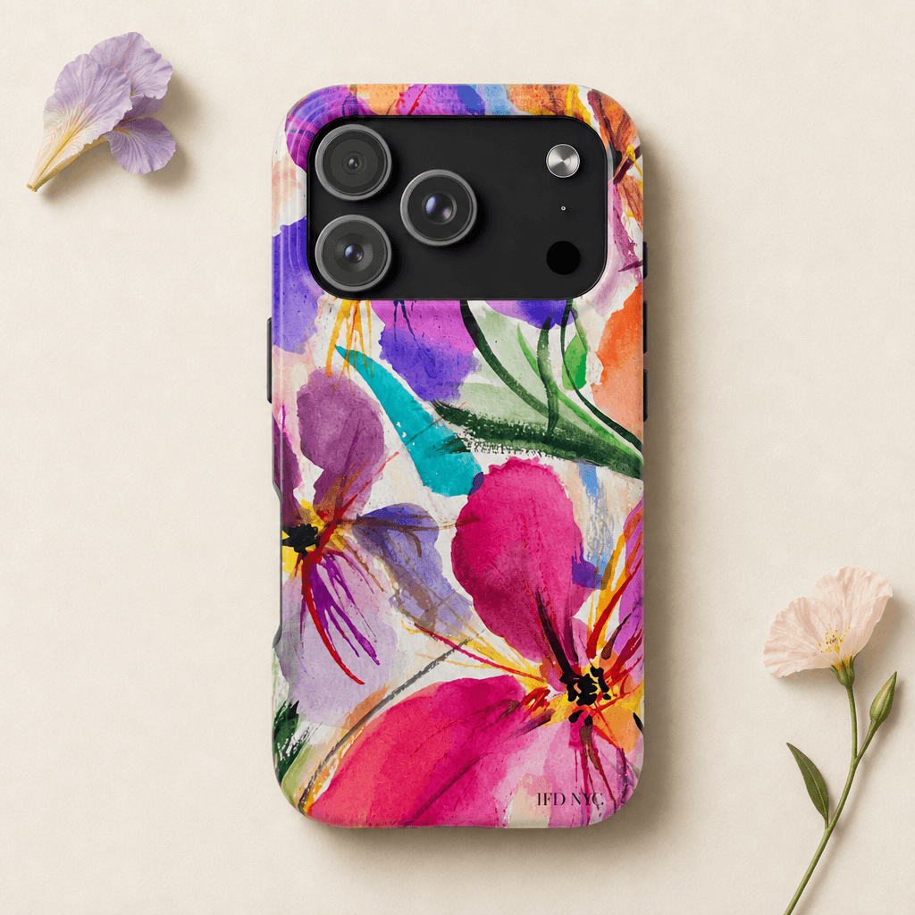 A phone case with a colorful watercolor floral print, shown on a light beige background with small decorative flowers in the corners. The case features a black camera cutout and has the brand name 'IFD NYC' printed near the bottom. 